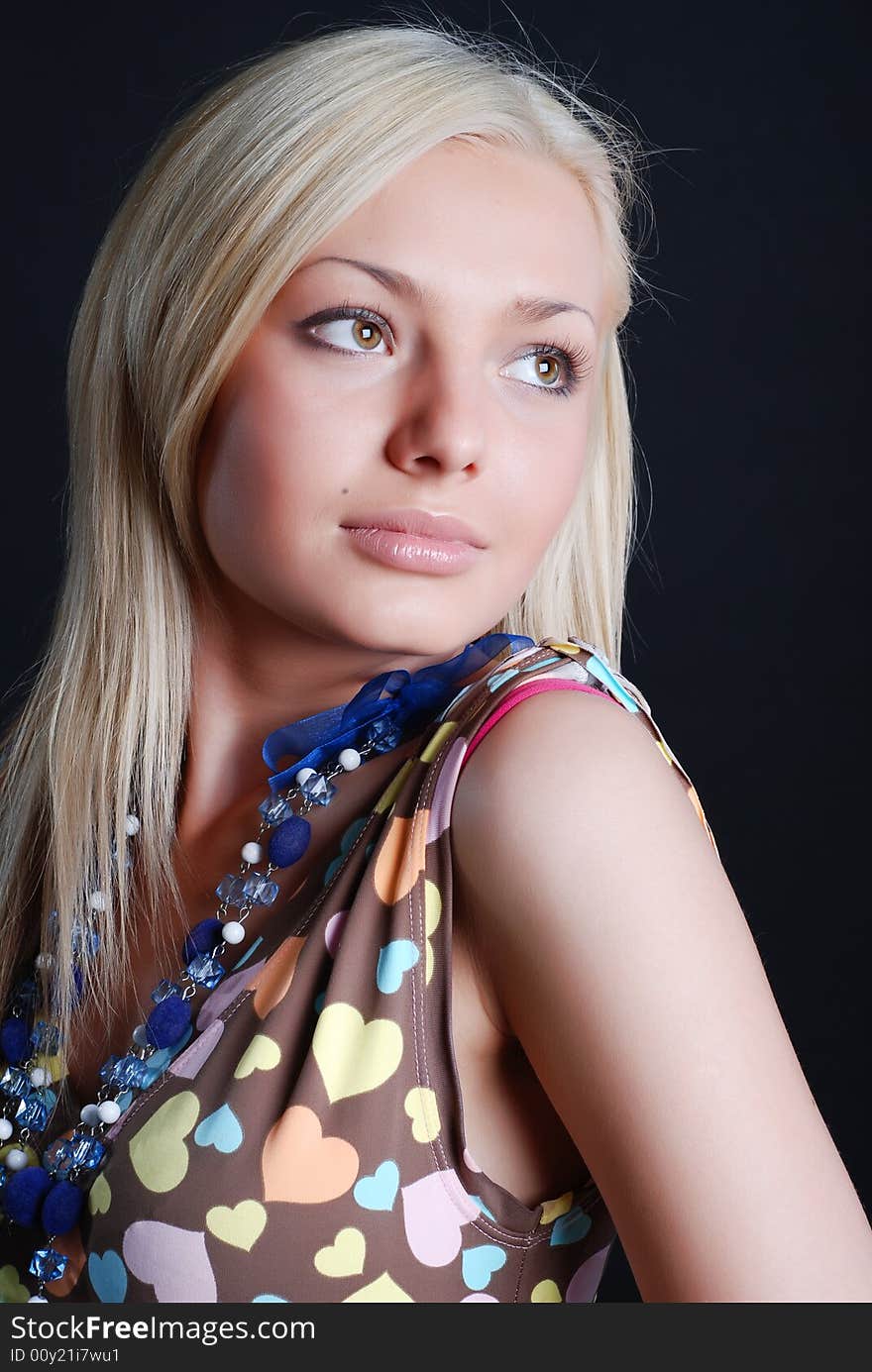 The beautiful girl in a sundress with a beads on a neck and a bracelet on a hand. The beautiful girl in a sundress with a beads on a neck and a bracelet on a hand