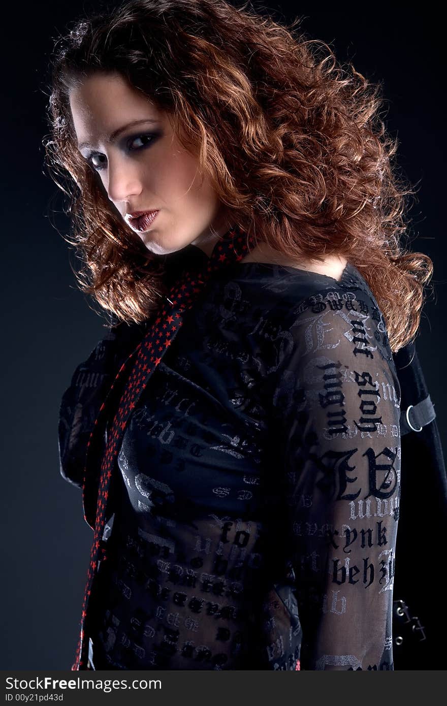 Portrait of a woman with long curly hair looking confident at you