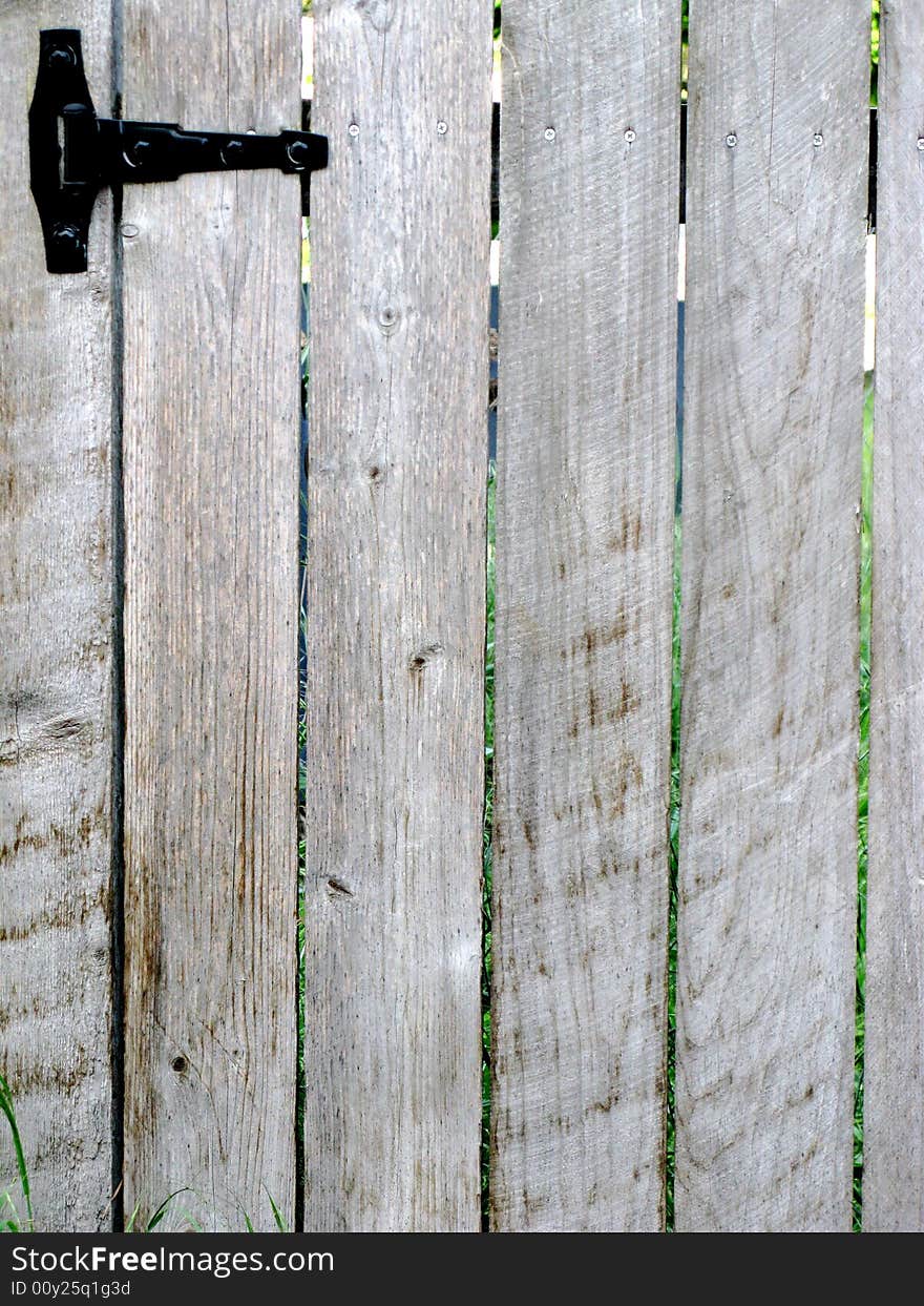 Wood garden gate with black hinge.