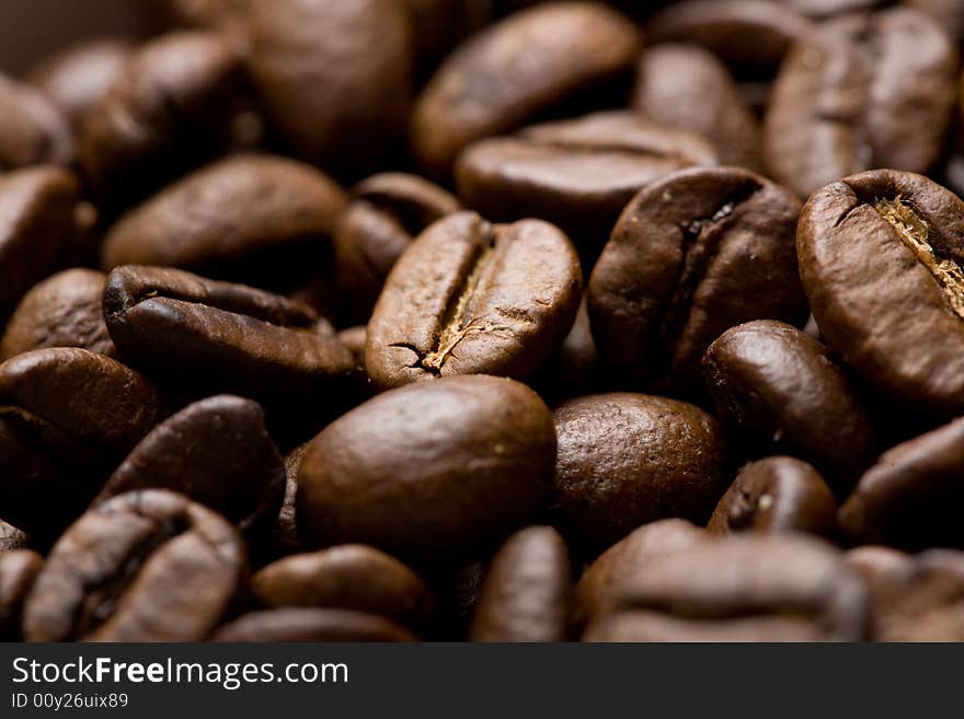 Freshly roasted coffee beans on sackcloth Shallow depth of field. Focus on center of image