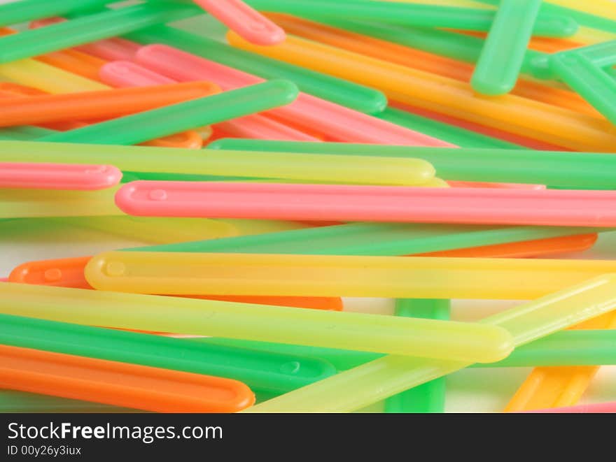 Heap of color sticks of yellow, orange, green and red colors form a background