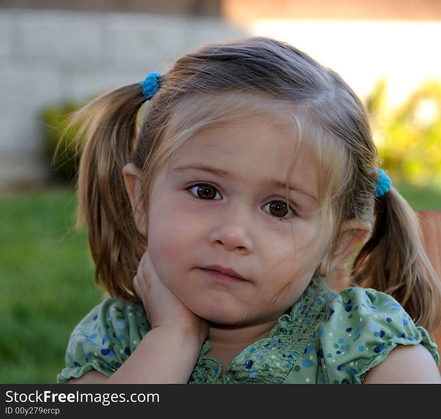 Little Girl with pony tails listening