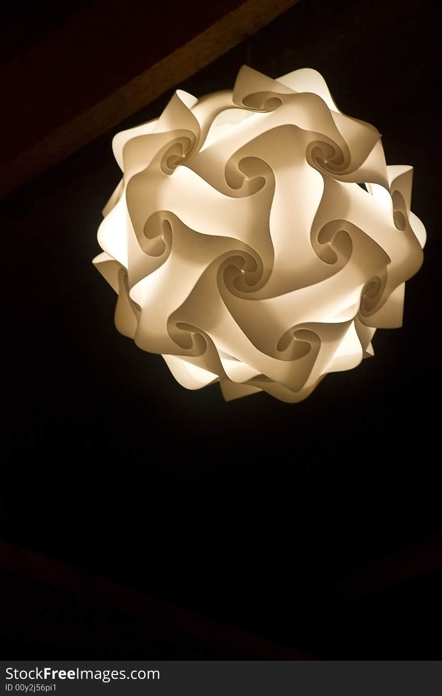 A white plastic lamp on a black background