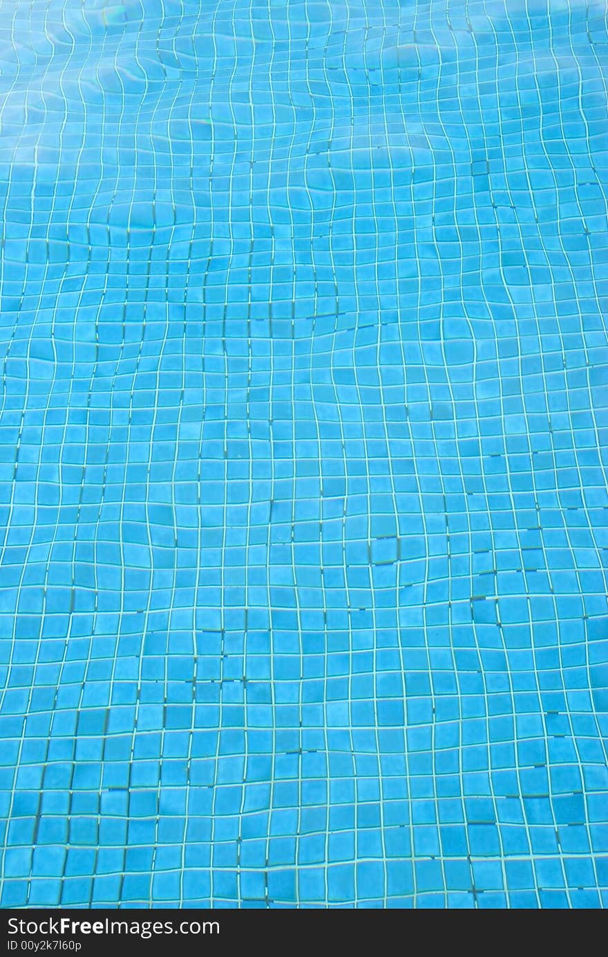 An image of the blue bottom of a swimming pool  distorted by water. An image of the blue bottom of a swimming pool  distorted by water