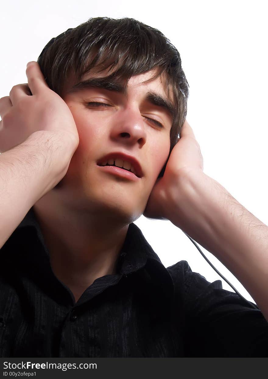 A portrait about a trendy attractive young guy who is smiling and he is relaxing with music. He is wearing a stylish black shirt.