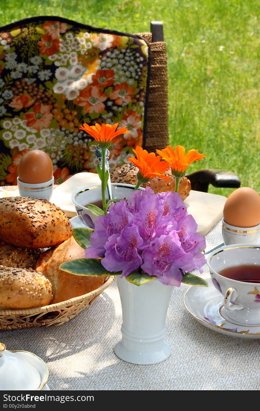 Cups of tea and simple food on a table in a garden. Cups of tea and simple food on a table in a garden.