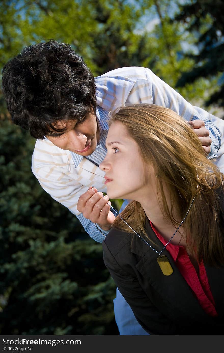 Boy  present a medallion for his girlfriend. Boy  present a medallion for his girlfriend