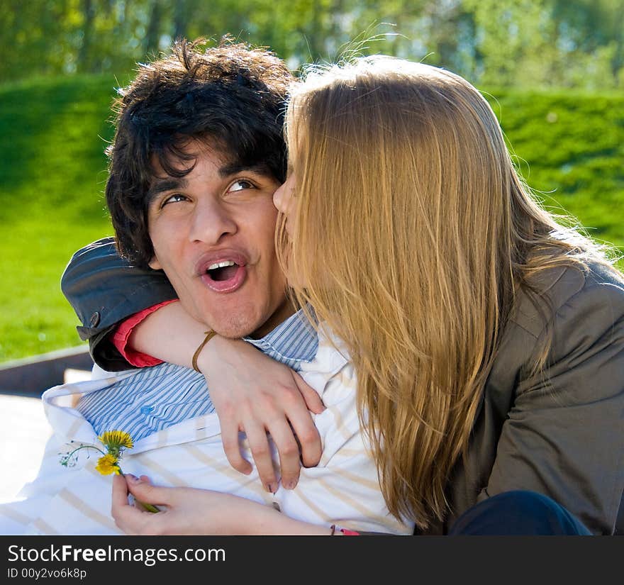 Happy pair of lovers embrace and kiss in the park. Happy pair of lovers embrace and kiss in the park