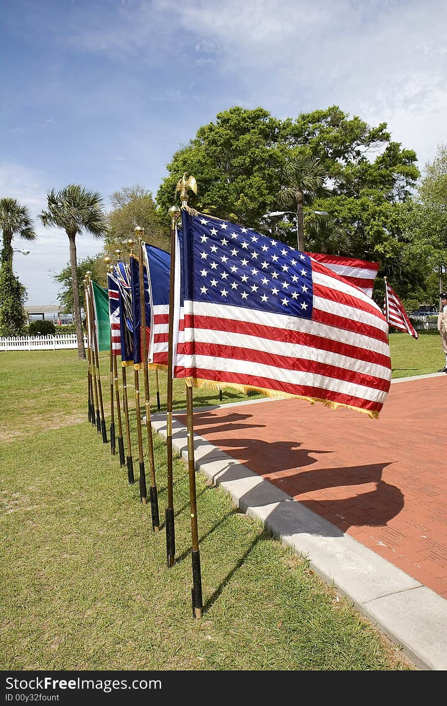 A line of historic american flags in a display at a park. A line of historic american flags in a display at a park