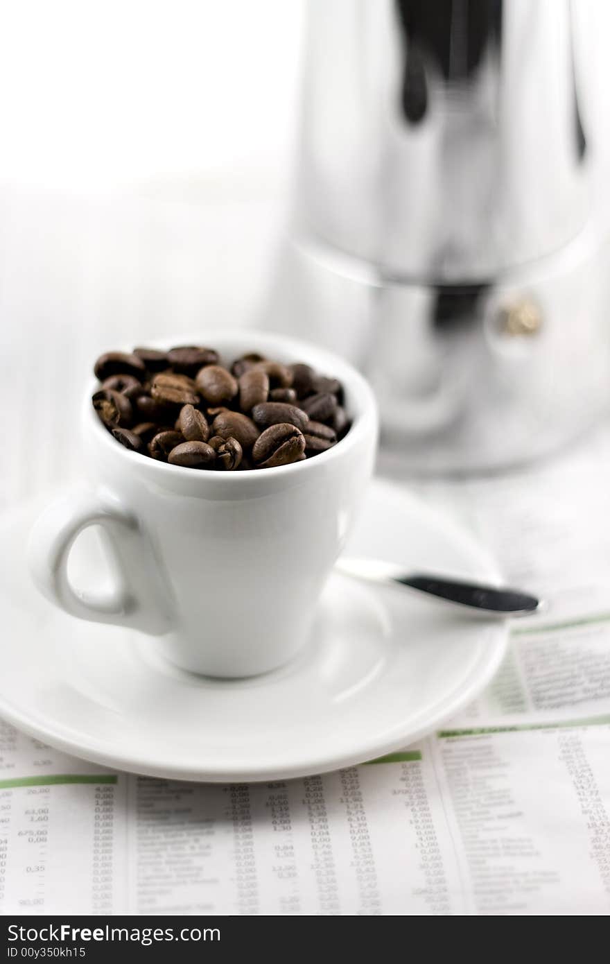 Mocca maker and coffee cup isolated on white background