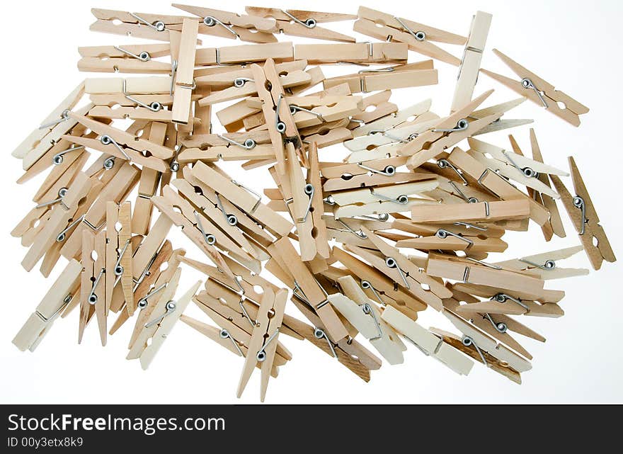 Pile of isolated wooden clothespins. Pile of isolated wooden clothespins