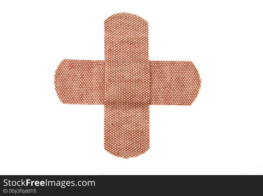 Bandages forming a cross isolated on white