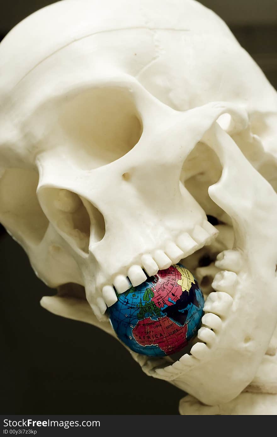 Skull eating a globe. A metaphor of the Climate change. Skull eating a globe. A metaphor of the Climate change