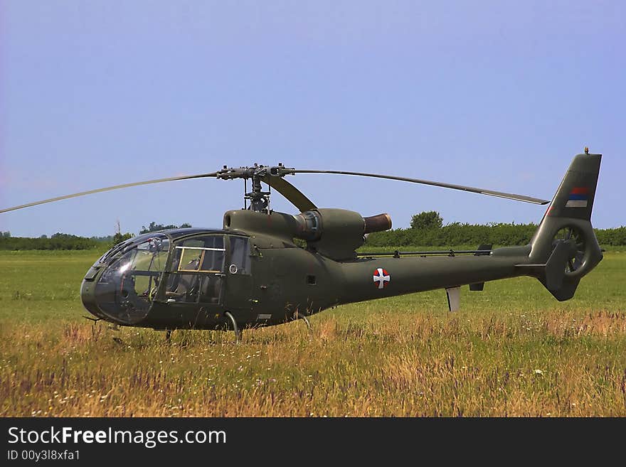 Military helicopter standing on the airfield.