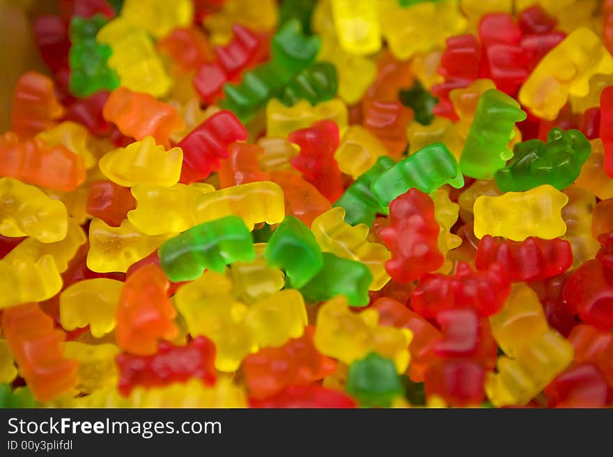 A photo of Multi-colored chewing bear shapped marmalade. A photo of Multi-colored chewing bear shapped marmalade