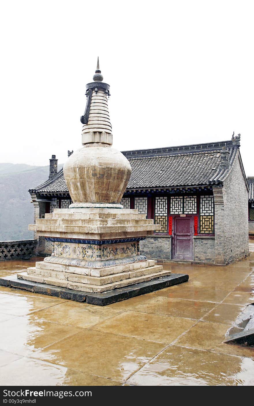 Tower in the ancient temple. 
This tower has already had a history of a thousand years.

Chinese characters on the door of background and both sides are a text of Buddhism.