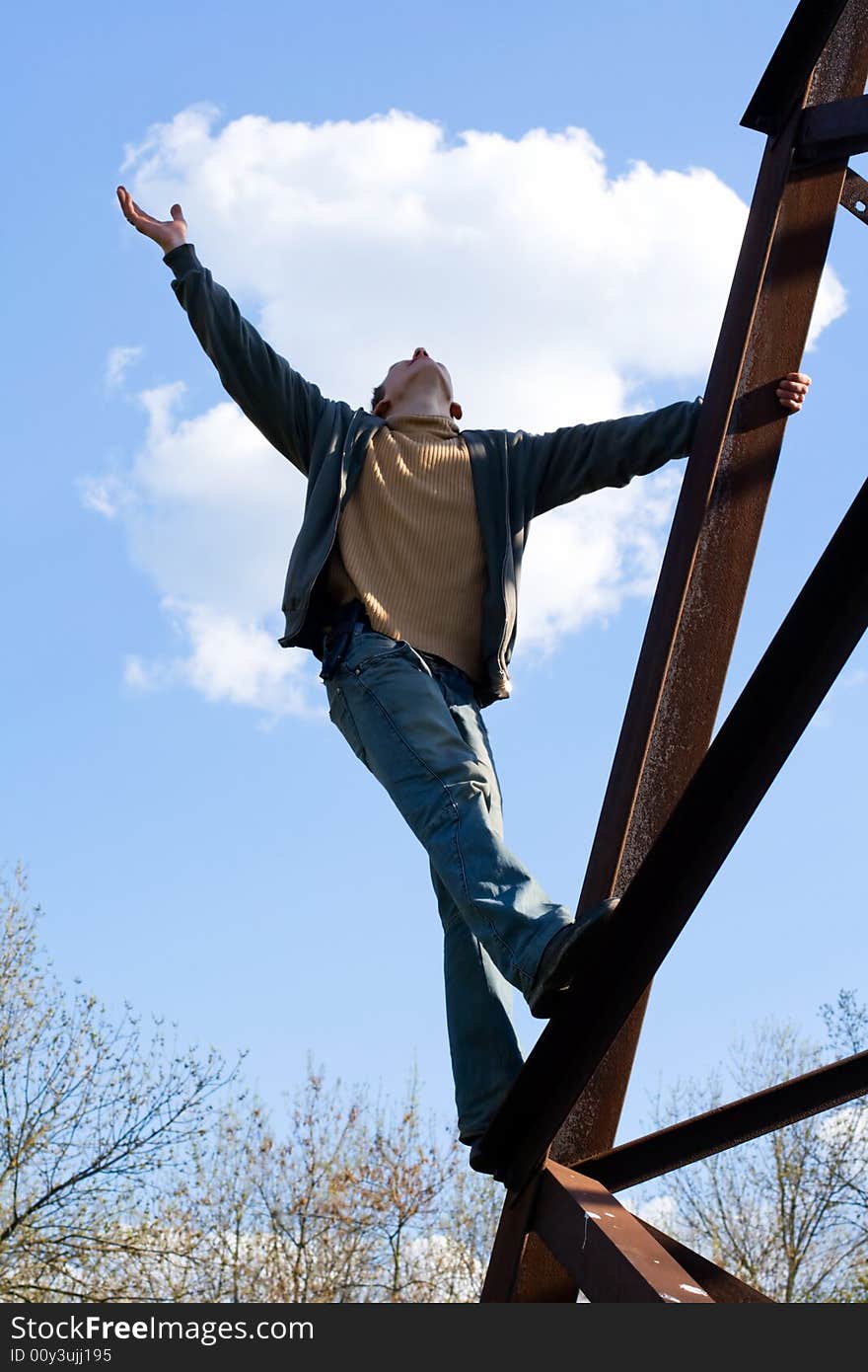 Man against a background of blue sky and clouds