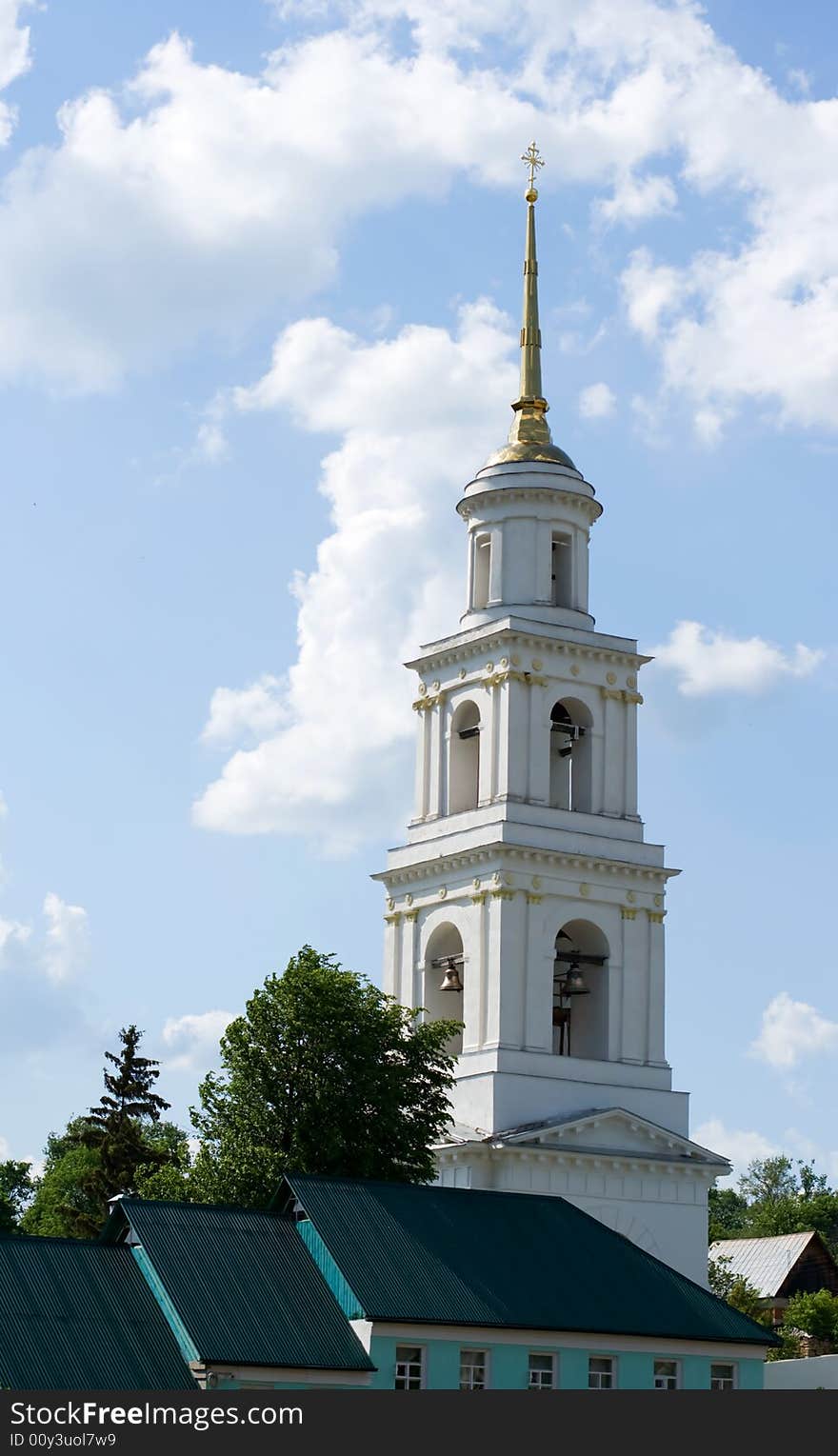 White bell tower against a background of blue sky