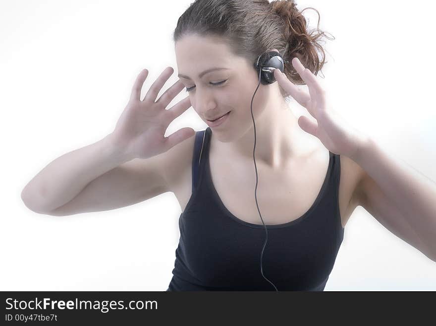 Portrait of a woman with long curly hair listening to music on her head[hone. Portrait of a woman with long curly hair listening to music on her head[hone