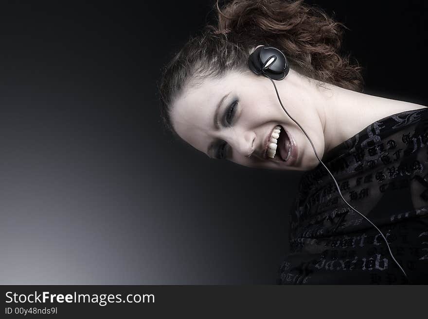 Portrait of a woman with long curly hair and headphones. Portrait of a woman with long curly hair and headphones