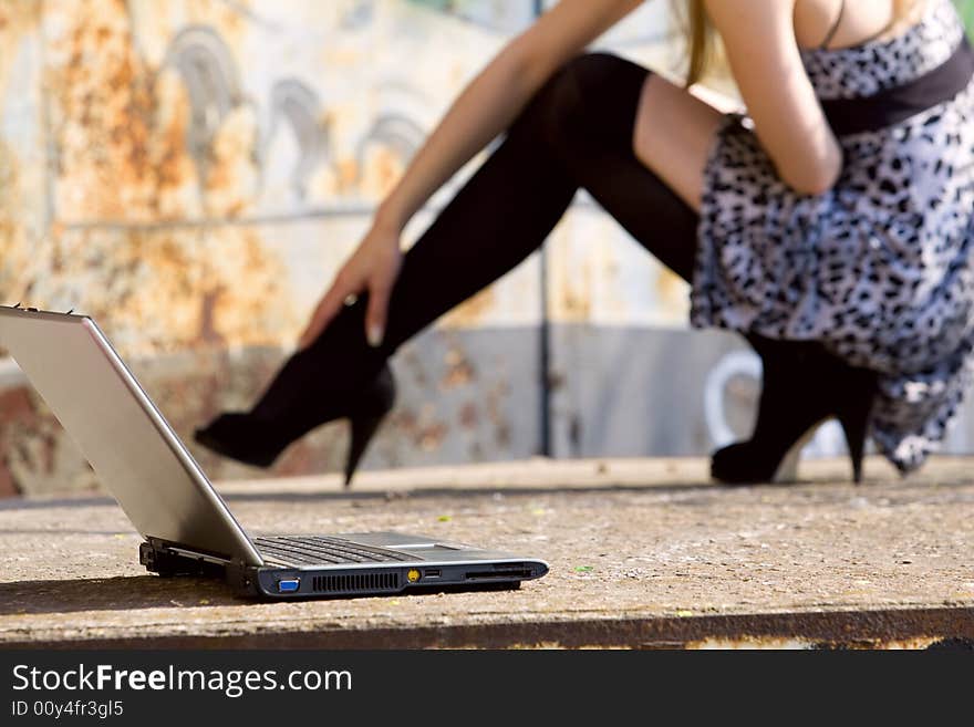 Casual shot with long legs and laptop