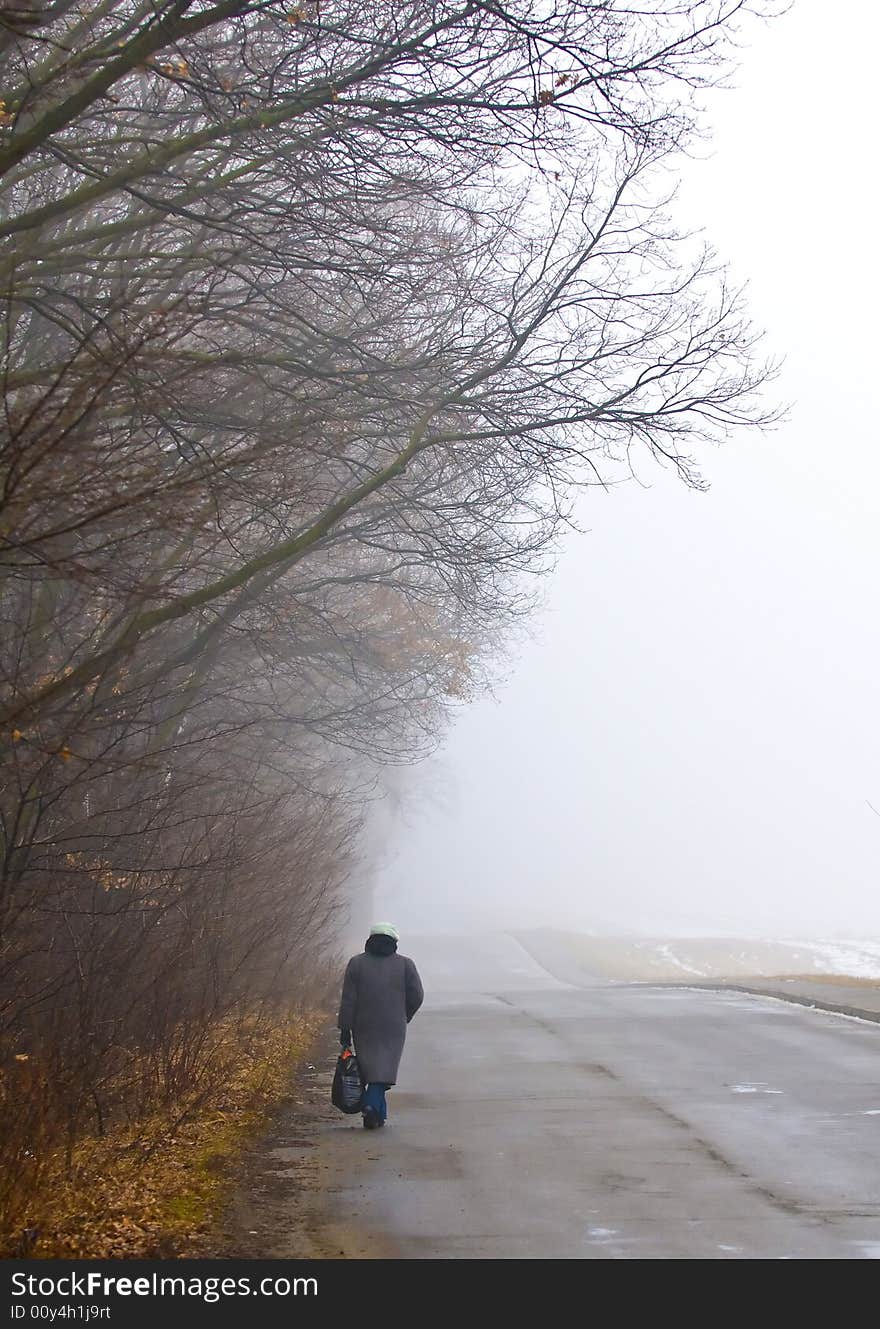 Woman walking in foggy day in the ukranian countryside. Woman walking in foggy day in the ukranian countryside