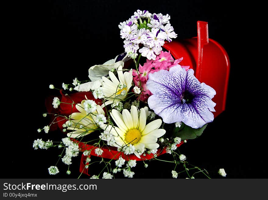 Bouquet of fresh flowers in a red mailbox. Bouquet of fresh flowers in a red mailbox.