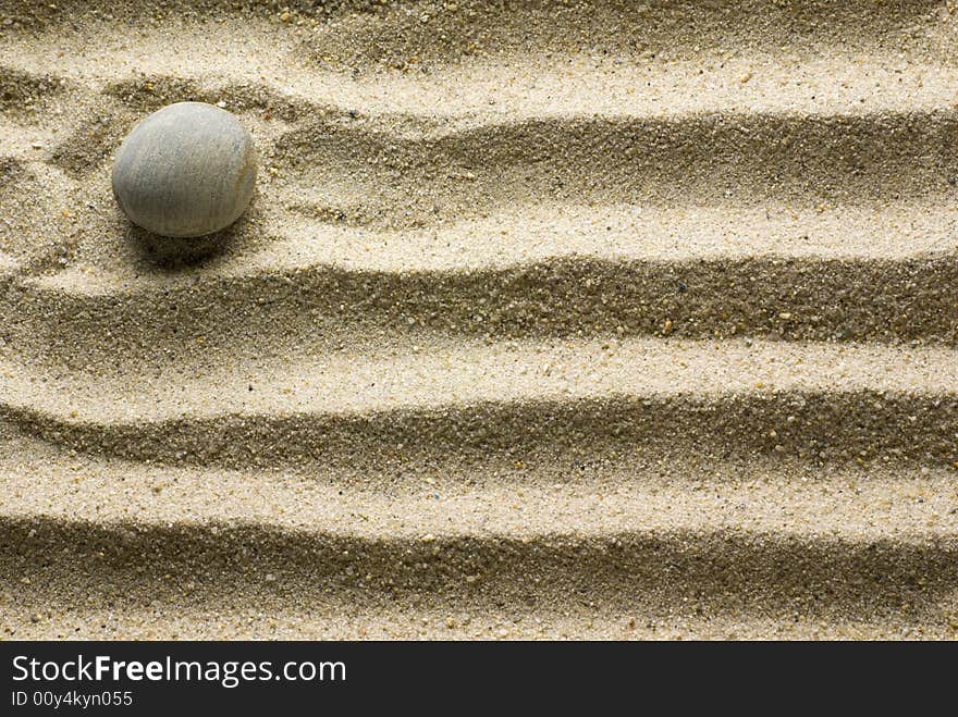 Sand pattern with pebble on it