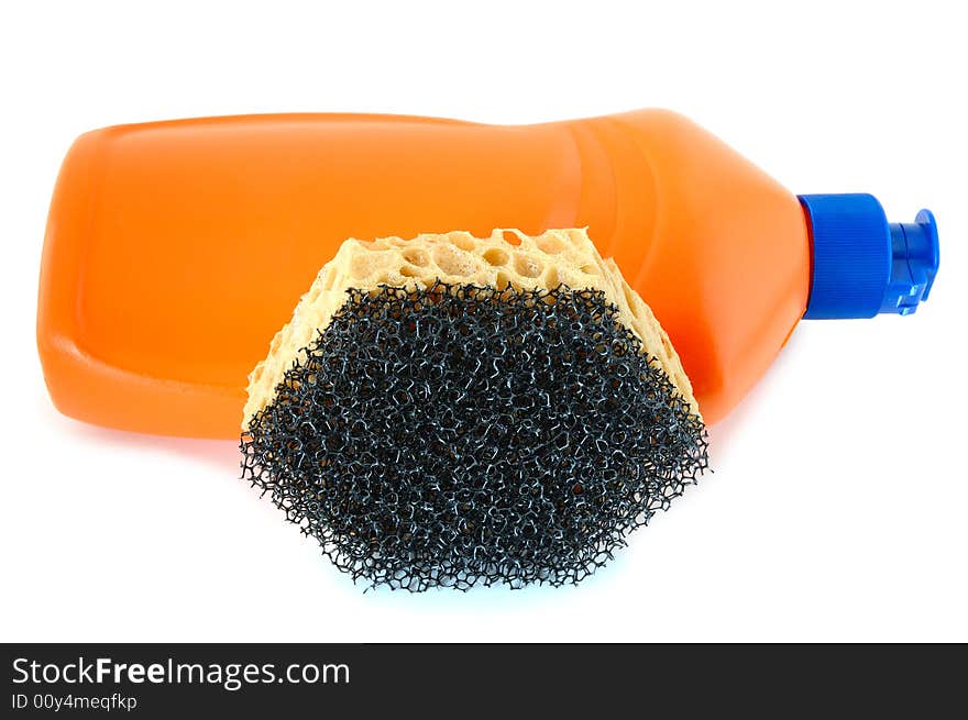 Detergent in orange plastic bottle and sponge on isolated background. Detergent in orange plastic bottle and sponge on isolated background