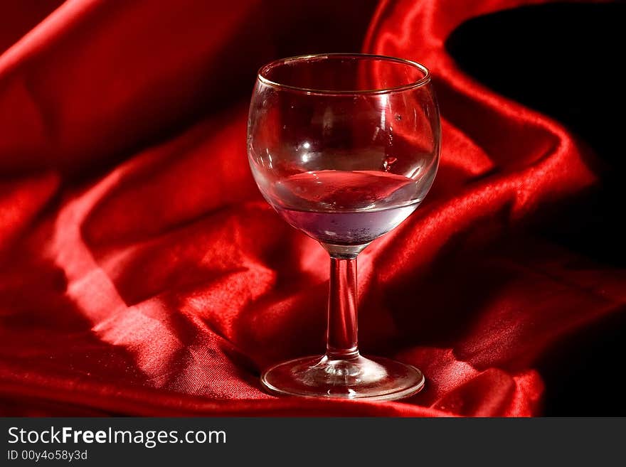 A glass of water over a red background. A glass of water over a red background