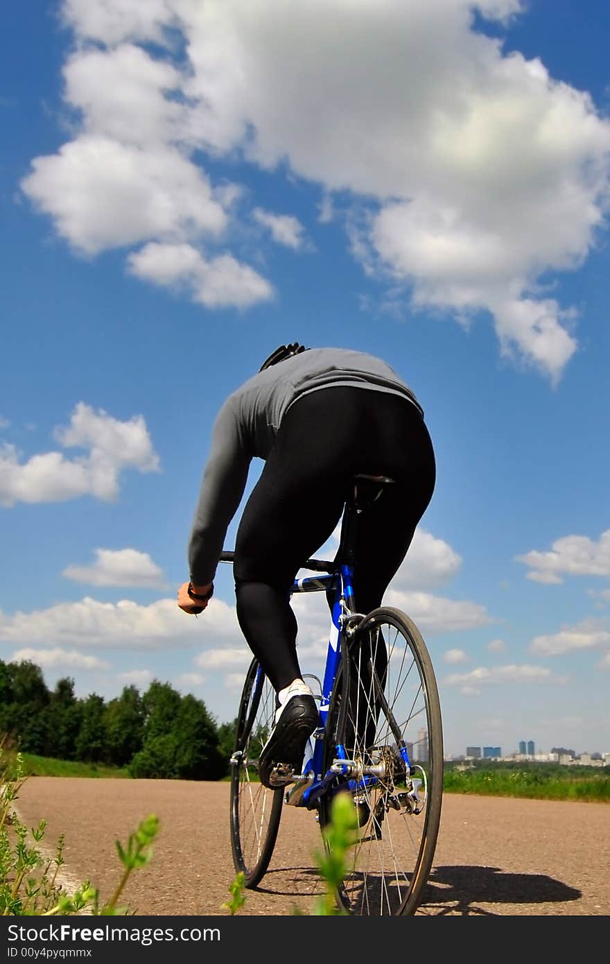 Bicyclist on a background of the sky