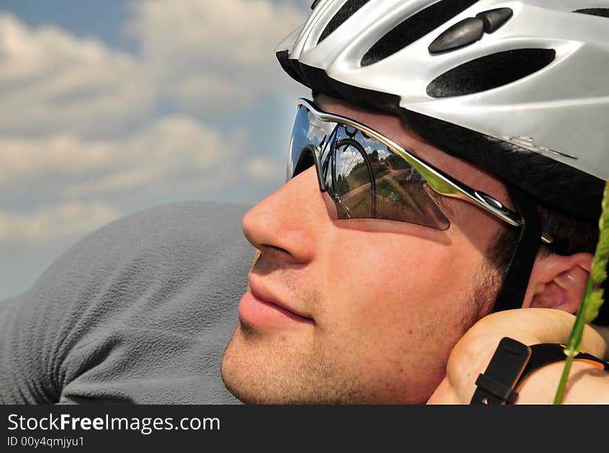 Bicyclist on a background of the blue sky. Bicyclist on a background of the blue sky