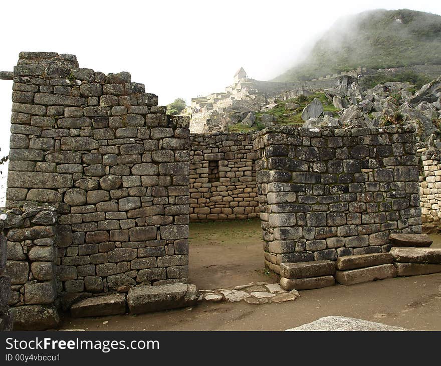 The lost city of the inca Machu Picchu in Cuzco, Peru. Inca window. Machu Picchu cover with clouds.