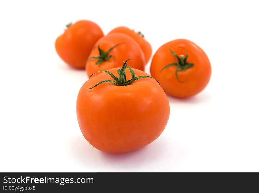 Red tomatos isolated on white. Red tomatos isolated on white