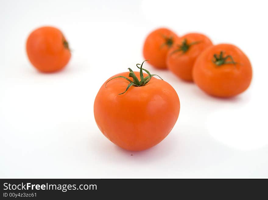 Red tomatos isolated on white. Red tomatos isolated on white