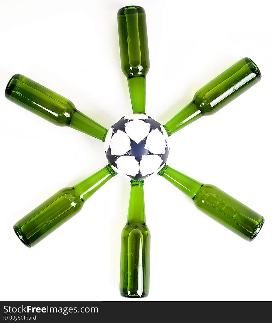 Beer bottles forming a star around a soccer ball. Beer bottles forming a star around a soccer ball