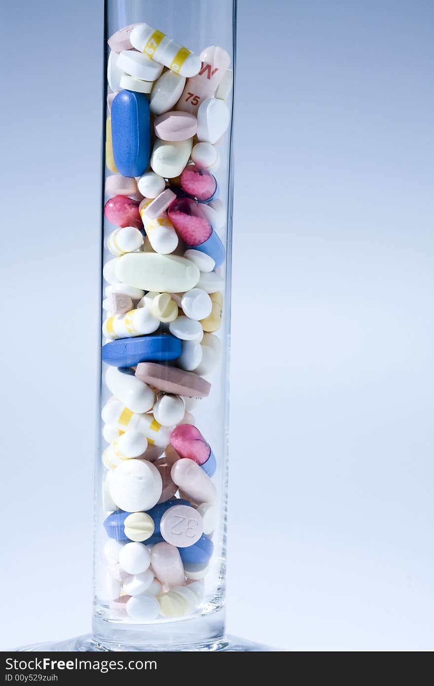 A jar filled with pills on white