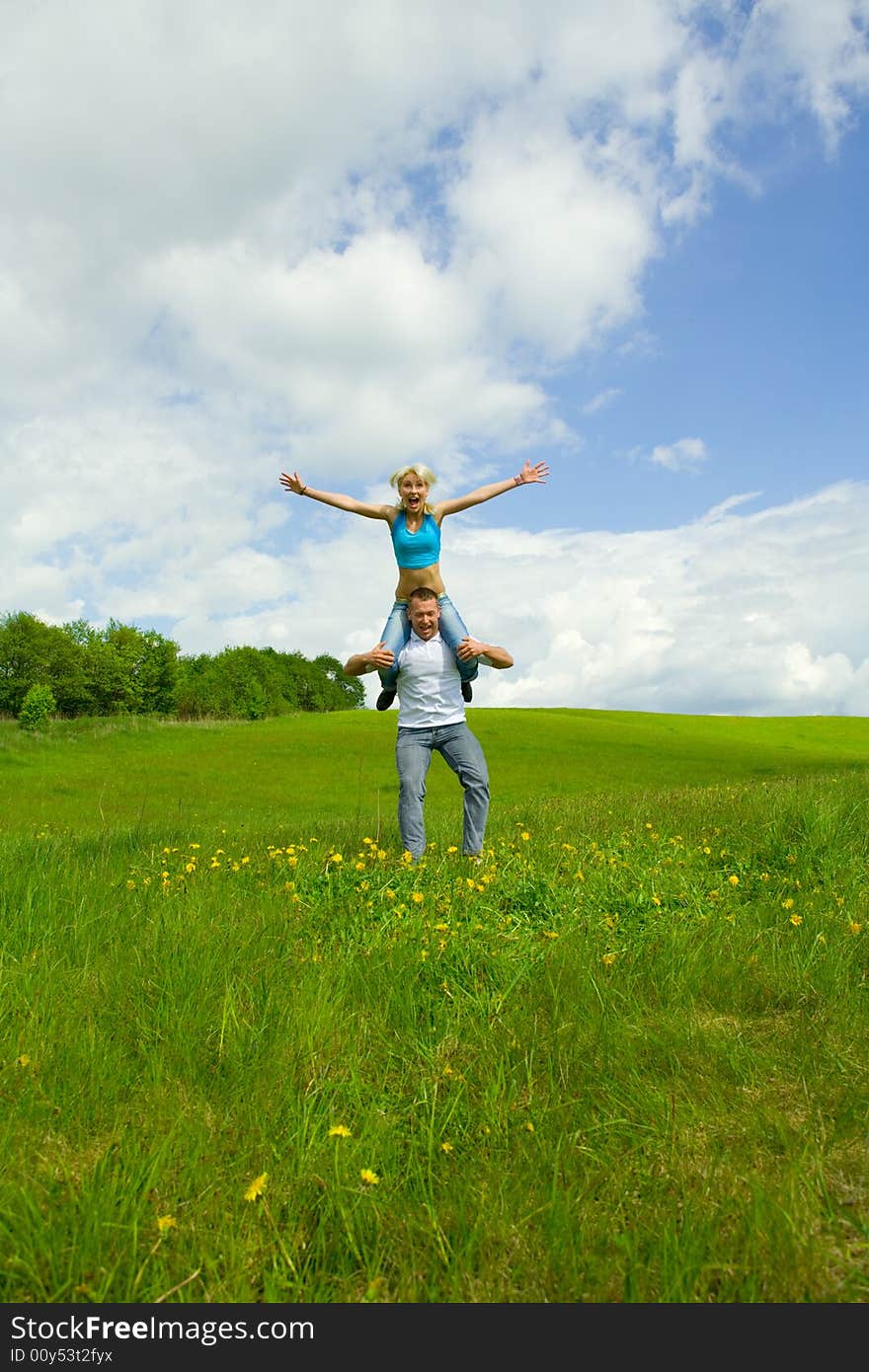 Young family jumping on a lawn