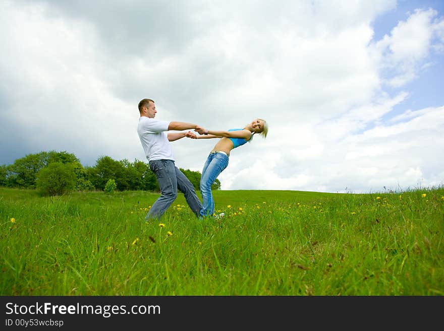 Young family jumping on a lawn