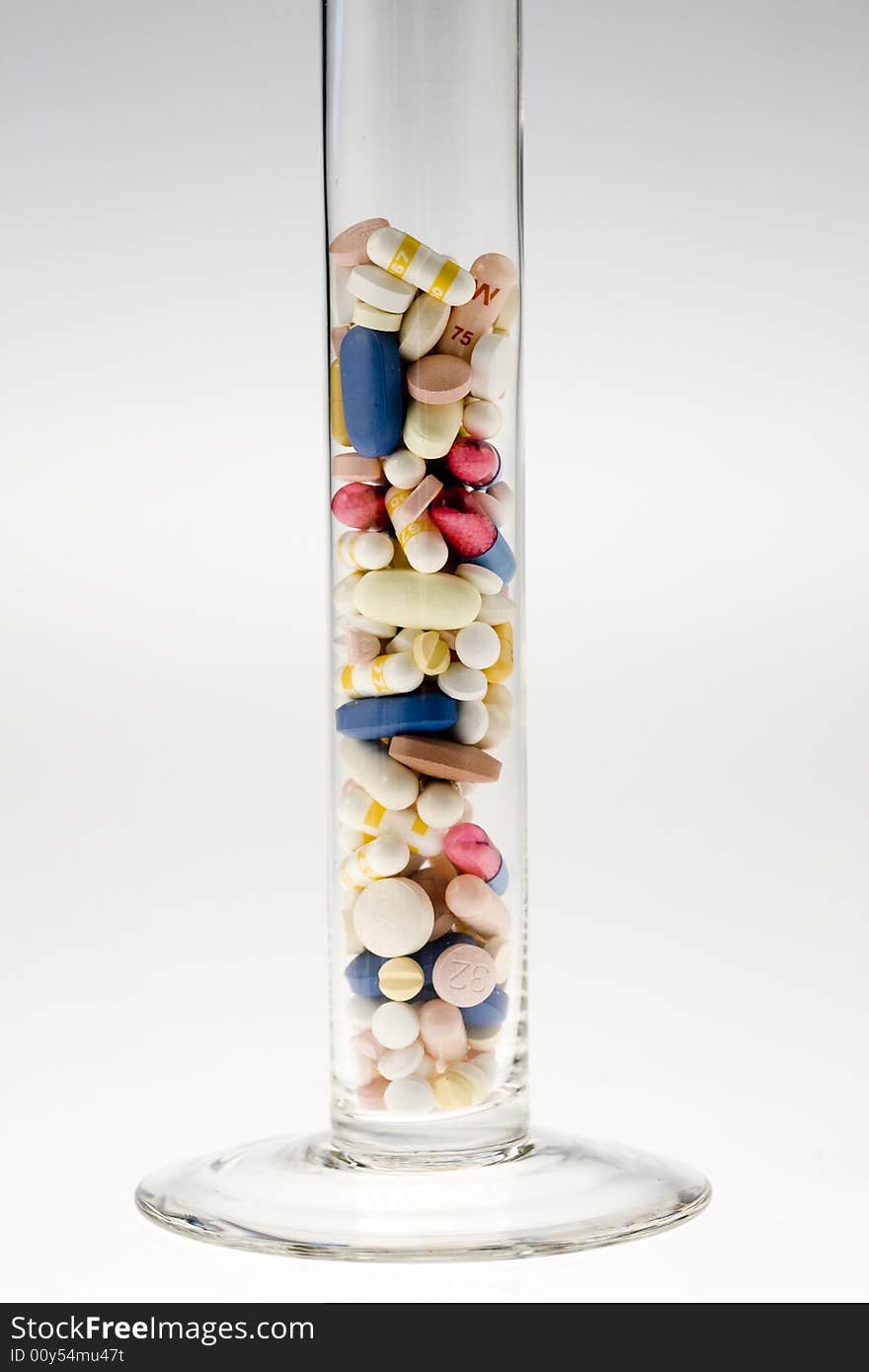 A jar filled with pills on white