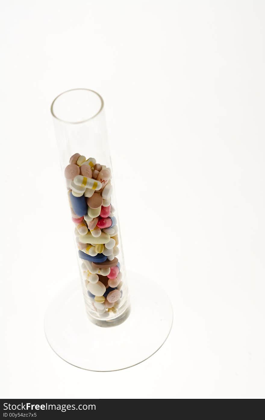 A jar filled with pills on white