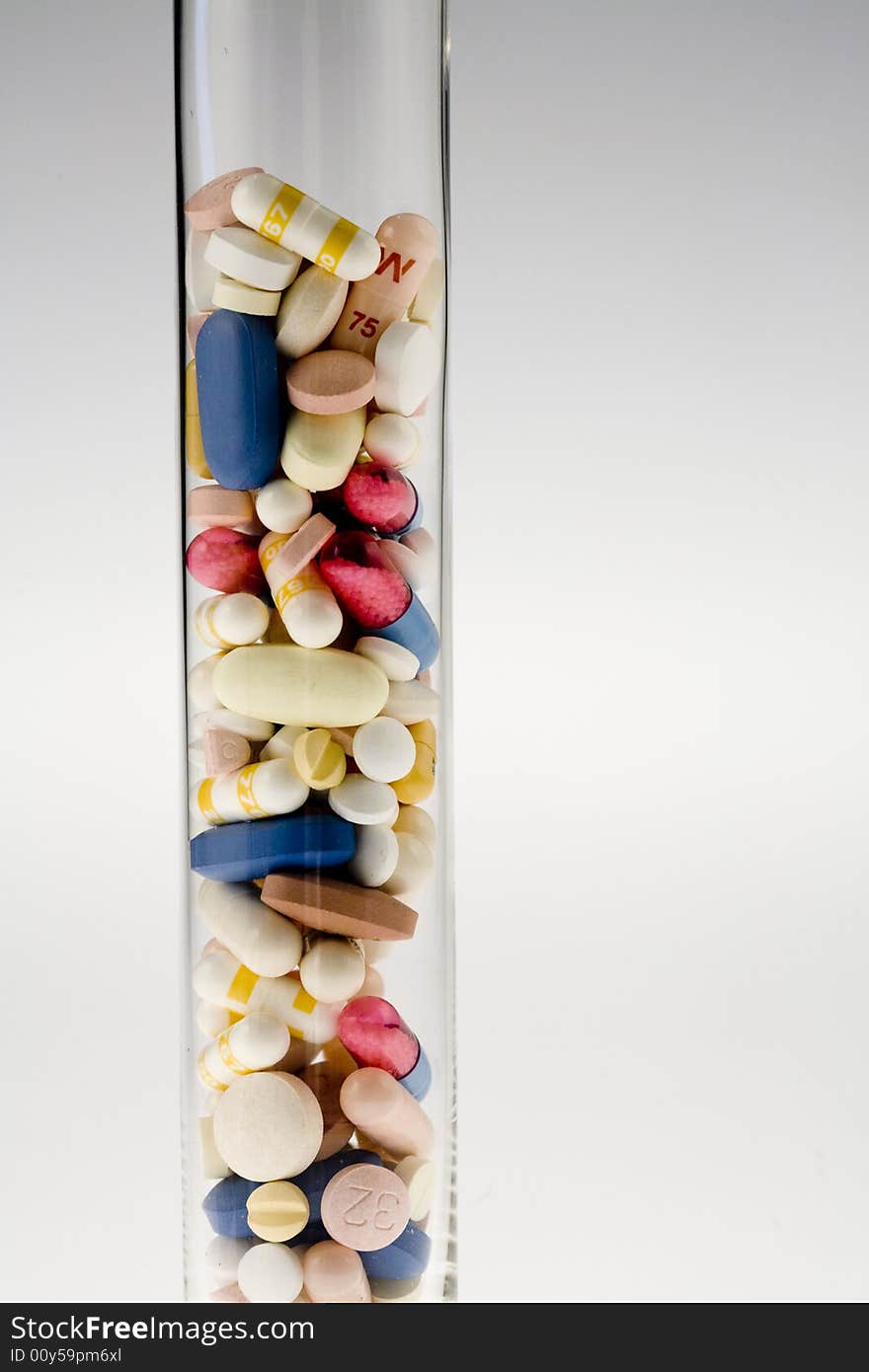 A jar filled with pills on white