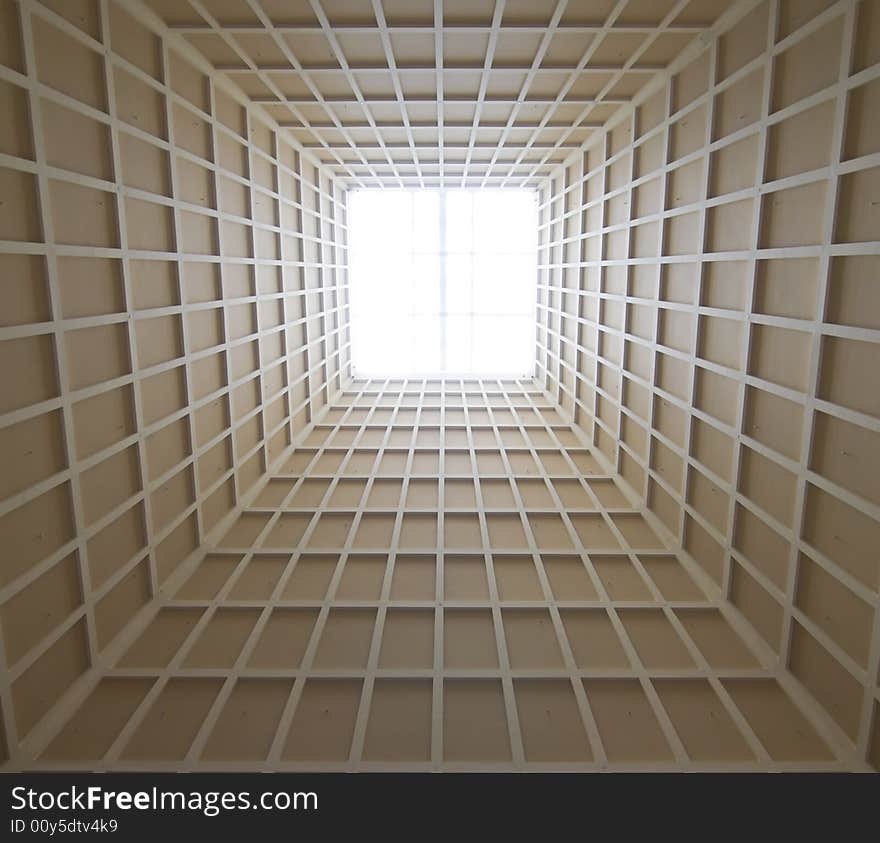 Tapering pyramid ceiling with skylight in the interior of a modern building