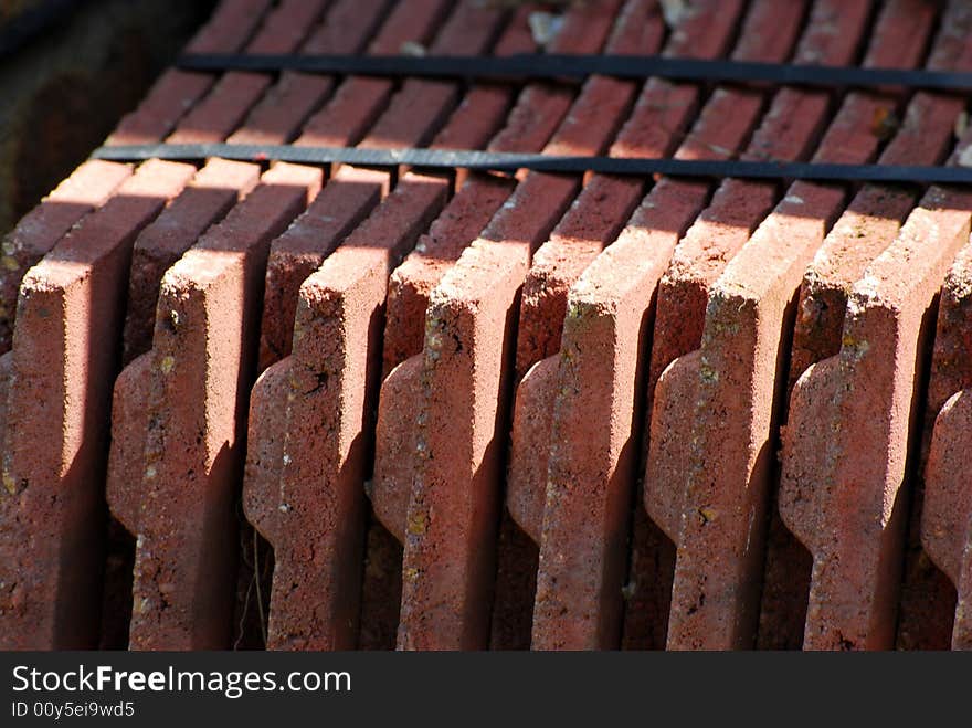 Shot of a tied bundle of red roof tiles. Shot of a tied bundle of red roof tiles