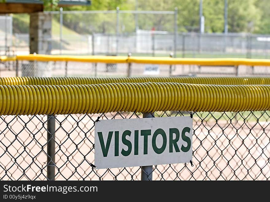 The view from the visitors dugout at a softball field