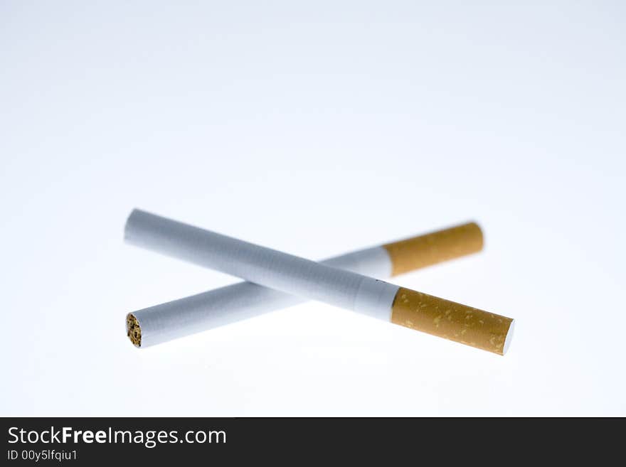 Two intertwined cigarettes on a white background