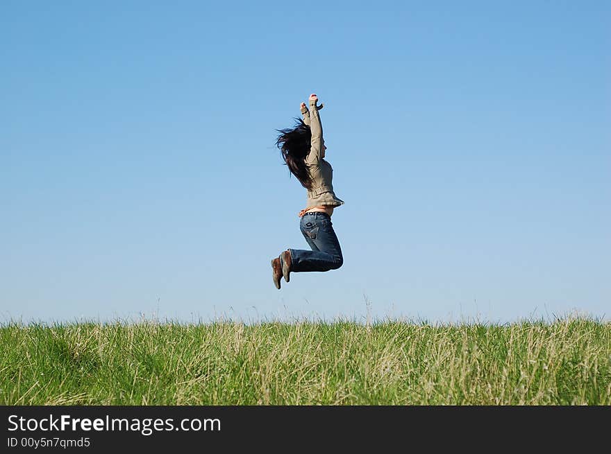 Happy woman jumping on green meadow. Happy woman jumping on green meadow