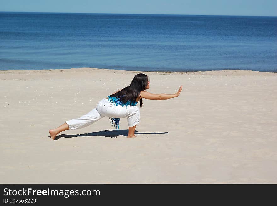 Woman doing exercise on the beach. Woman doing exercise on the beach