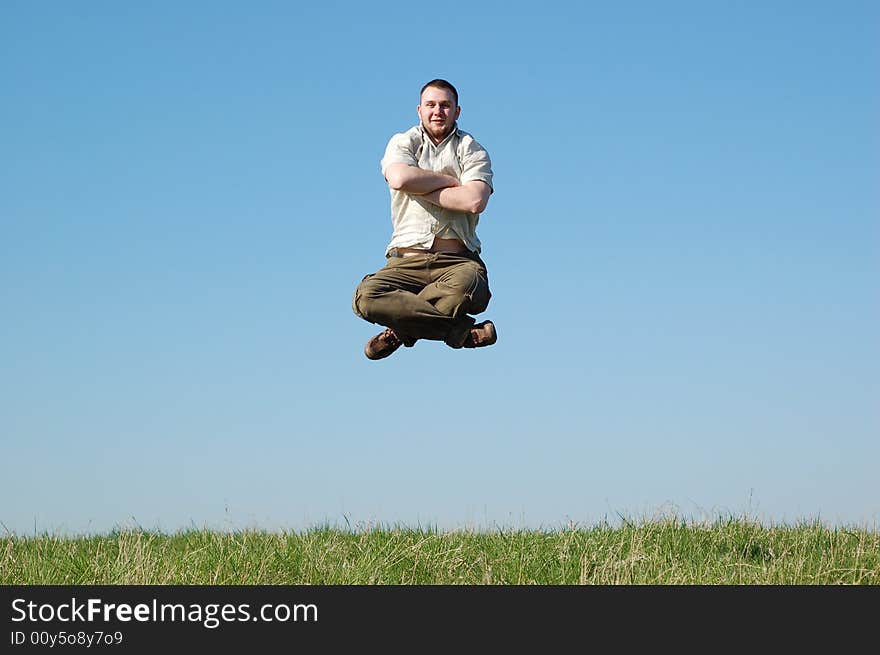 Happy man jumping on green meadow. Happy man jumping on green meadow