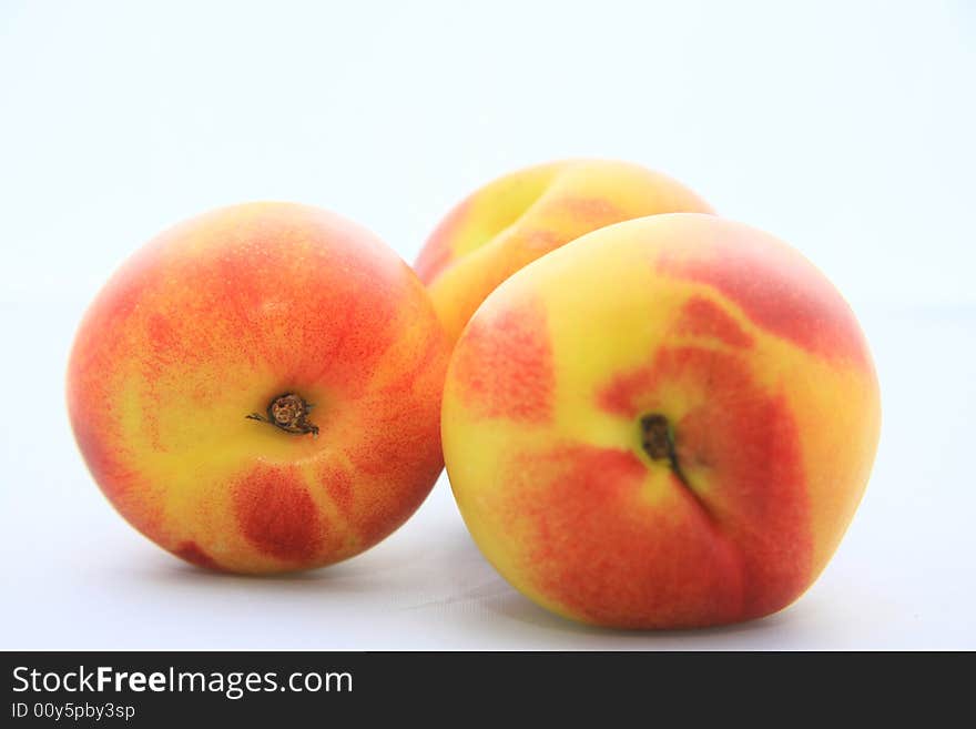 Some nectarines on white background